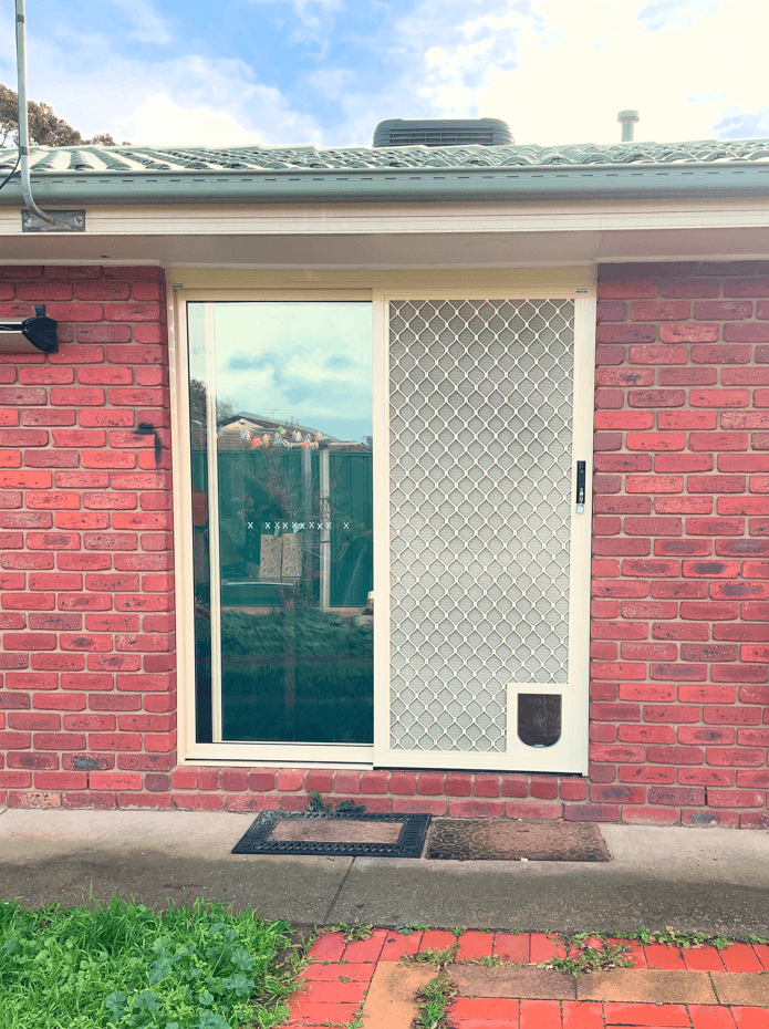 Small pet door on diamond grille door